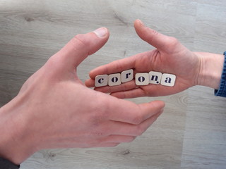 Corona handshake symbolized with text in hand