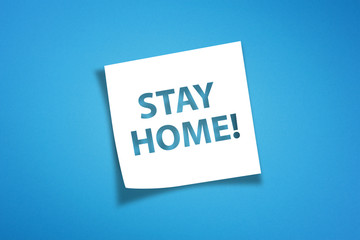 Note paper with stay home message on blue background