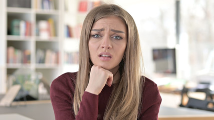 Fototapeta premium Portrait of Sad Young Woman having Loss, Failure