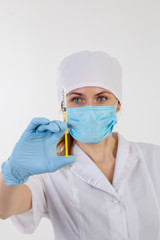 Doctor in a white coat holding a syringe.