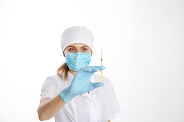 Fototapeta premium Doctor in a white coat holding a syringe.
