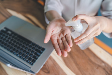 The woman's hand was washing her hands with an alcohol gel in a pump-like bottle to prevent the spread of the Covid-19 virus.Photos from the top view