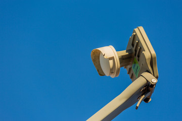 Satellite Dish Device with Clear Blue Sky in the Background