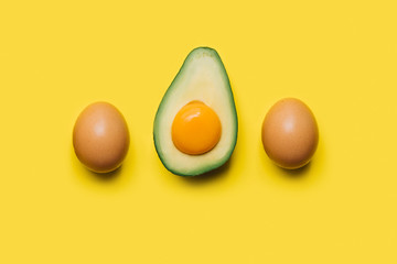 yolk in avocado and eggs on a yellow background. easter concept
