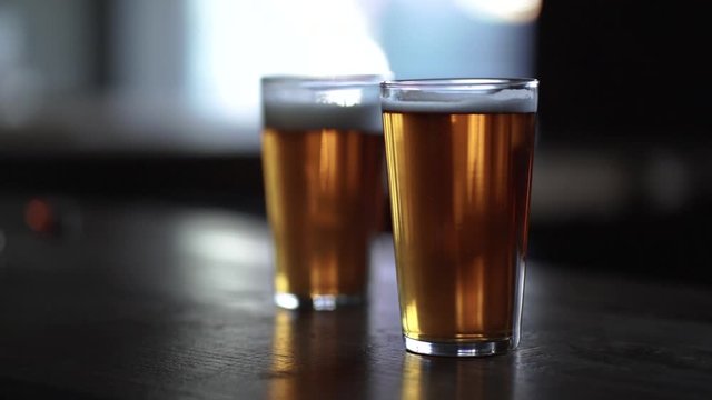 two pints of beer with rising bubbles