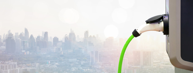 Power supply for electric car charging. Electric car charging station. EV Car battery charger at charge station electro mobilit. Environment friendly Car. Panoramic banner