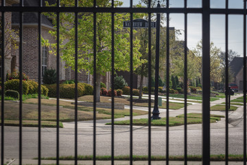 Shallow DOF on the metal fence of gated residential area in suburbs Dallas, Texas