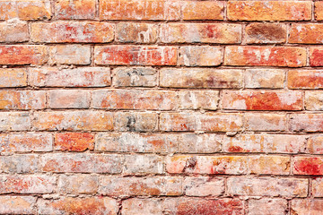 Texture of a brick wall with cracks and scratches which can be used as a background