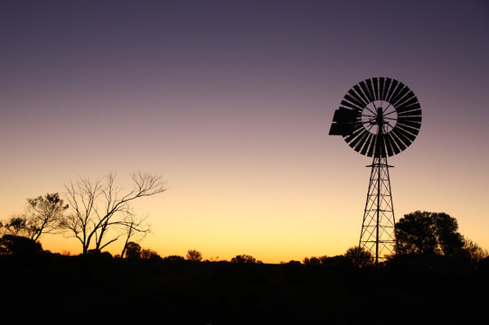 Sunset in Australian desert with windmill silhouette 