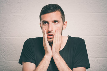 Young businessman holding head in his hands