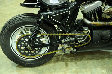 Motorcycle chain. It is a metallic chain that is used to transmit power from the engine to the rear wheel.