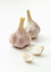 Young garlic and segments on a white background