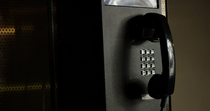 Payphone just inside dark building - close up