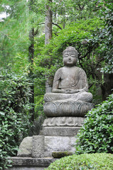 Sculpture of a Buddha statue in a zen garden. Kyoto, Japan.