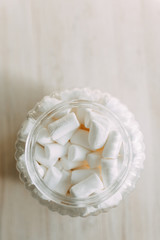 Dessert with coffee on the table. White marshmallow in a glass container in a coffee shop.