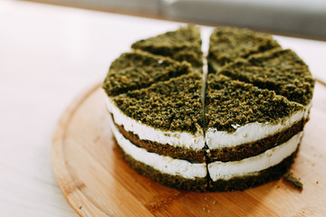 Green natural spinach cake, vegan. Layer cake with spinach and cream.