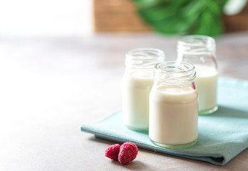 Fermented drink kefir in a glass jar on a light background. Probiotic cold fermented dairy drink.