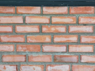 Red brick block wall show Pattern stack block rough surface texture material background Weld the joints with cement grout red color paint