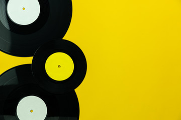 Table Top view of musical instrument retro concept.Flat lay objects of the many music disk on modern rustic yellow paper at home office desk.copy space for creative design text and word.