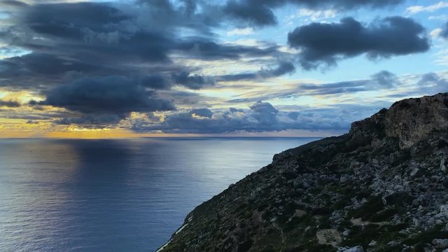 Apocalyptic sunset over the ocean. Dark clouds drifting over the sky and covering the sun. Timelapse.