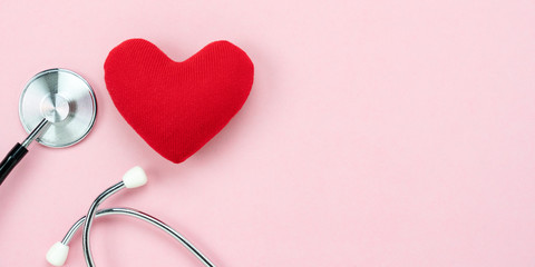 Table top view aerial image of accessories healthcare & medical with Valentines day background concept.telescope with colorful heart shape on pink paper.Flat lay items for doctor using treat patient.