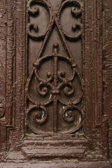 The pattern on the doors, painted in a dark brown color. Ancient architecture