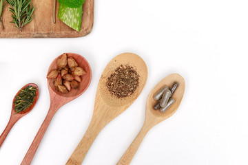 Top view of Herbal medicine preparation with fresh herbs and dried flowers, aromatherapy essential oil and mortar with pestle used in natural alternative remedies on white table.