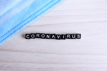 Word coronavirus laid with cubes letters flat lay composition