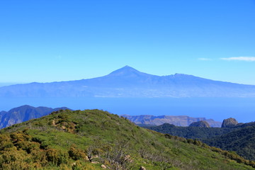 Fototapeta na wymiar View over the national park Garajonay on La Gomera. In the background the island Tenerife with the Volcano Pico de Teide