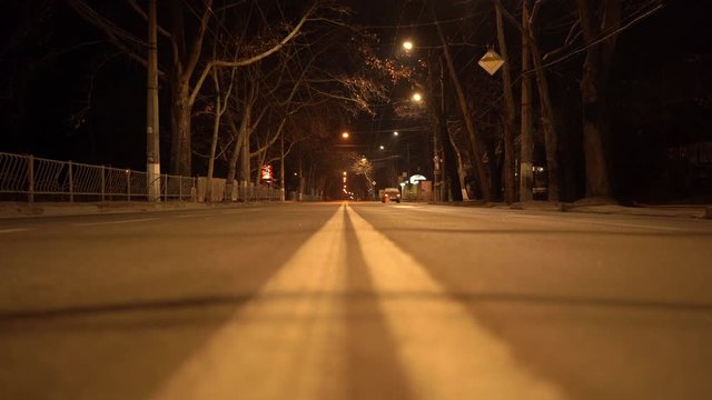 Simferopol empty city streets with street lights at night in autumn. Dividing line on the road.