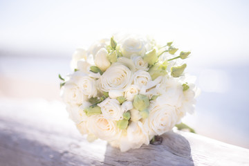 Beautiful white bridal bouquet by the sea 