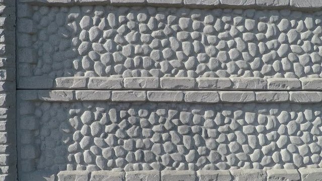 background texture section of concrete fence with a drawing of imitation stone