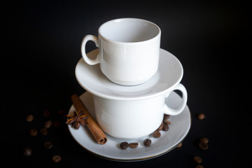 Large, medium, small cups for coffee against a dark background.