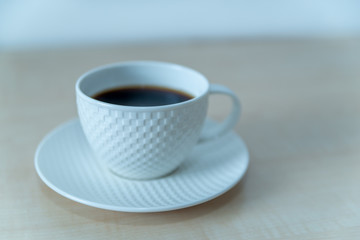 cup of coffee on wooden table