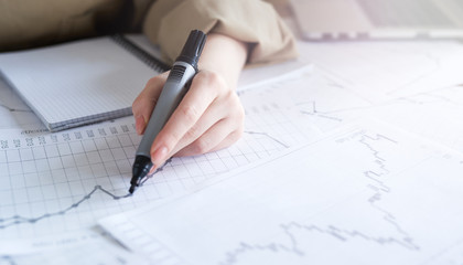 Close up woman hand working of Business graphics, analysis