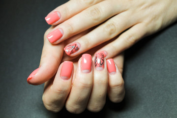 Fashionable gentle moon manicure gel Polish on natural nails with a geometric design on the hands of a well groomed woman