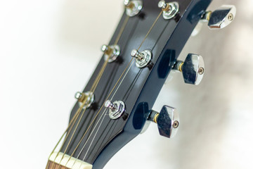 Close up of a blue guitar pegbox in a white background