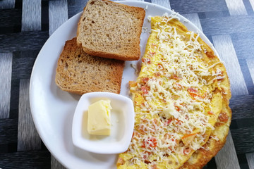 Breakfast of Spanish omelette with toast and butter on a plate