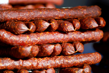 Close up of red pepper dried sausages on farmer market for sale