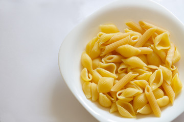Spaghetti pasta in a white dish on a white background.copyspace for text