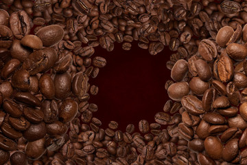 Close up. Tornado of coffee beans. Top view. On brown background