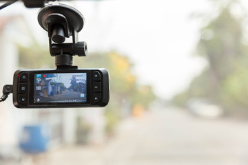 CCTV car camera for safety on the road accident. Video recorder driving a car on highway.A car dash cam mounted on the front windshield recording the traffic ahead in case of an emergency situation .