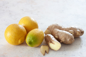 Ginger root and fresh lemons on a white background.Alternative medicine.Virus protection food,...
