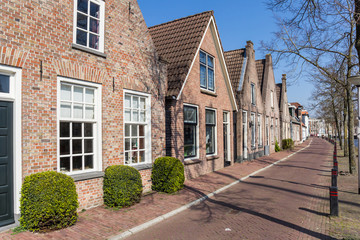 Fototapeta na wymiar Street lined with historic houses and trees in Meppel, Netherlands