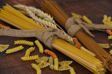 dried, wheat and rye spaghetti and pasta on a wooden table