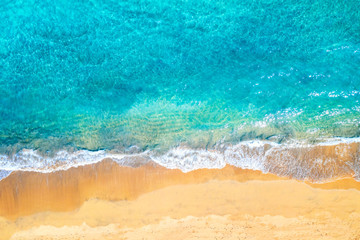 Top view aerial drone photo of ocean seashore with beautiful turquoise water and sea waves. Caribbean resort. Vacation travel background.