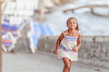 happy  little girl have fun and joy time at beautiful beach