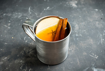 Apple cider in metal mug on the rustic background. Selective focus. Shallow depth of field.