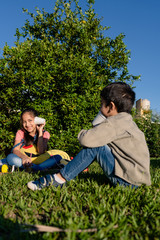 Fototapeta premium children play on the phone with cans in the patio of their house