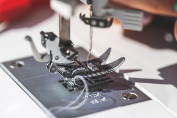 Sewing at home: Close up picture of sewing needle